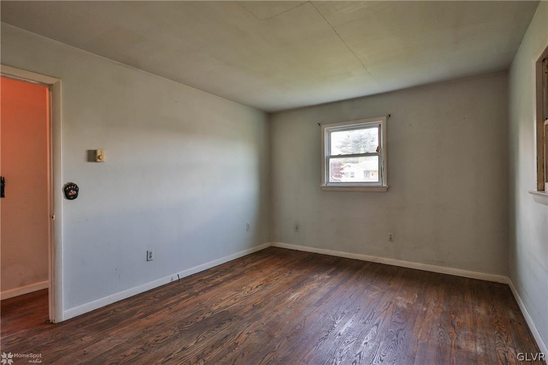 1034 Pine Tree Drive Slatington, PA 18080 - Photo 23 of 46 an empty room with wooden floor and windows