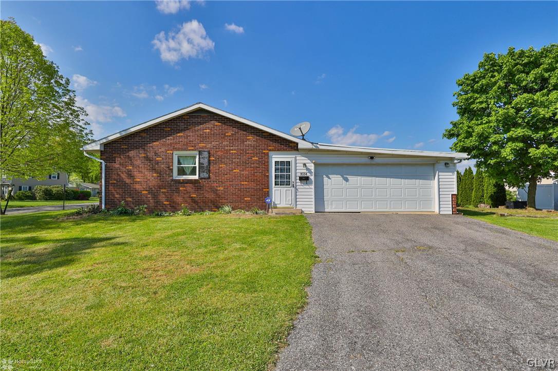 1034 Pine Tree Drive Slatington, PA 18080 - Photo 35 of 46 a front view of a house with a yard and garage