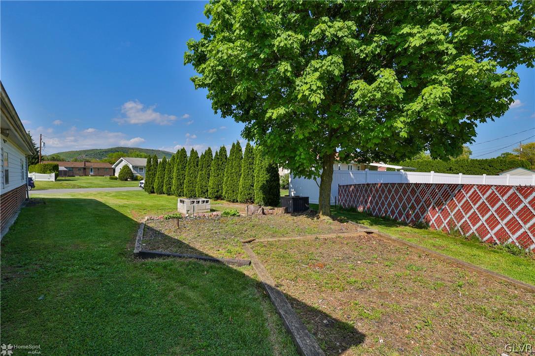 1034 Pine Tree Drive Slatington, PA 18080 - Photo 37 of 46 a view of a backyard with a garden and trees