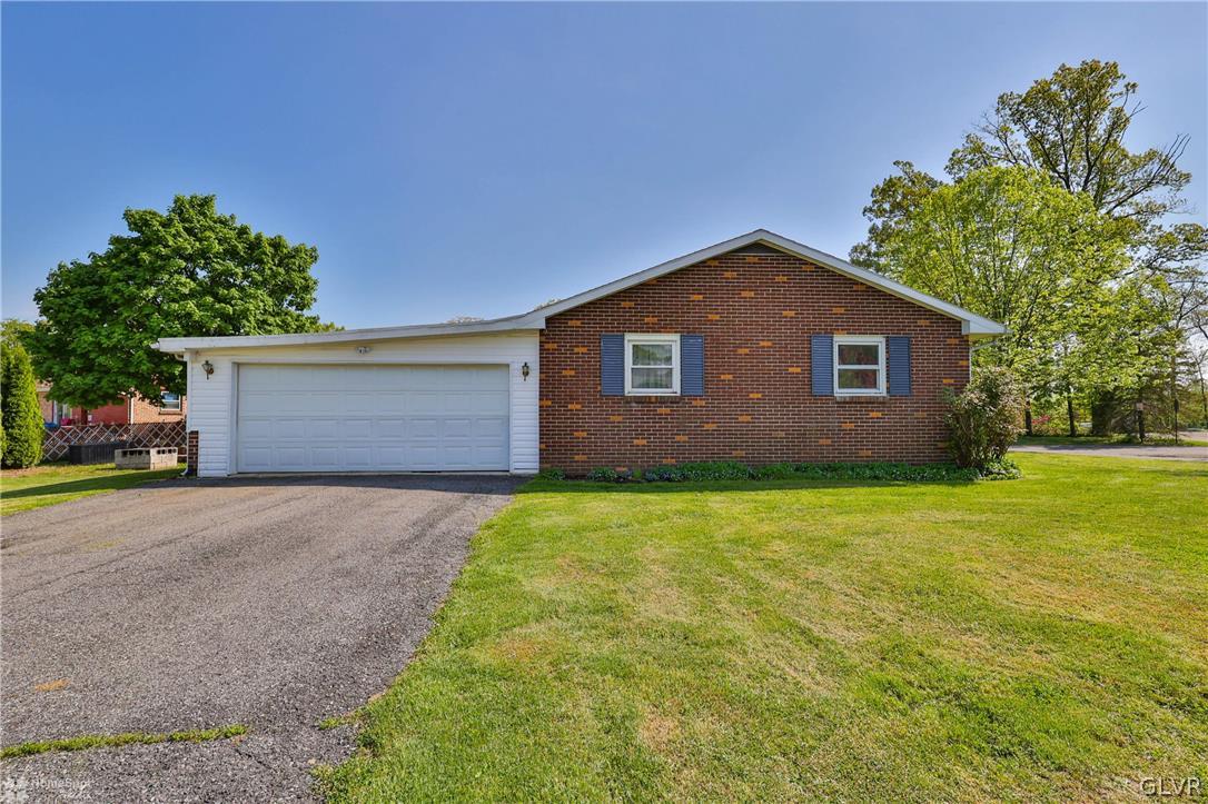 1034 Pine Tree Drive Slatington, PA 18080 - Photo 42 of 46 a front view of a house with garden