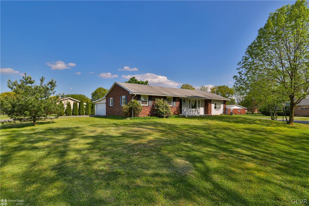 1034 Pine Tree Drive Slatington, PA 18080 - Photo 43 of 46 a front view of a house with a garden