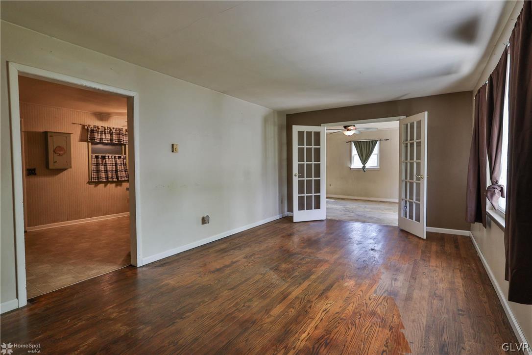 1034 Pine Tree Drive Slatington, PA 18080 - Photo 5 of 46 an empty room with wooden floor and windows