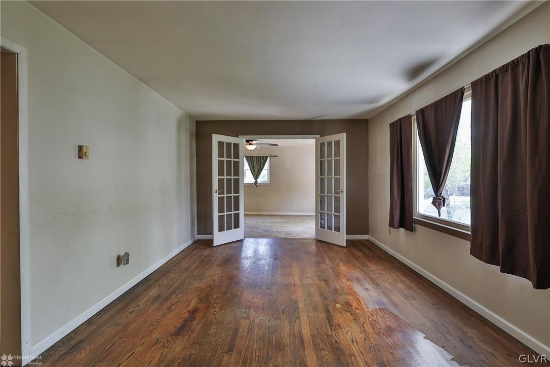 1034 Pine Tree Drive Slatington, PA 18080 - Photo 6 of 46 an empty room with wooden floor and windows