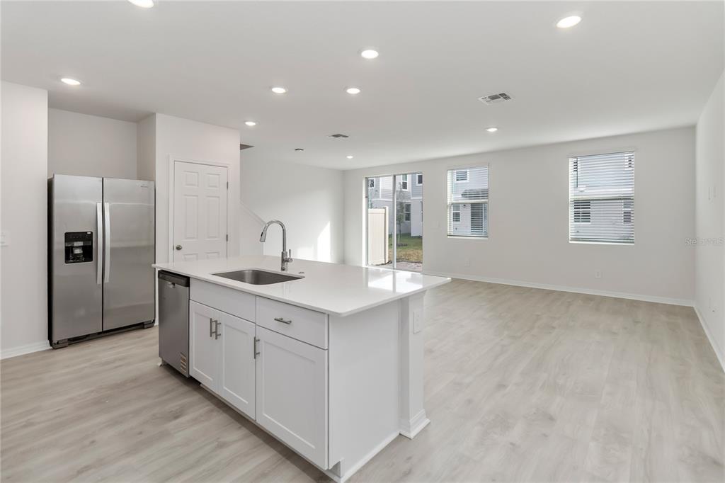 4569 Range Land Way St. Cloud, FL 34772 - Photo 13 of 41 a kitchen with stainless steel appliances granite countertop a sink a refrigerator and a stove