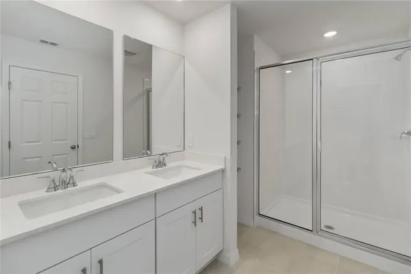 a bathroom with double sink and a mirror
