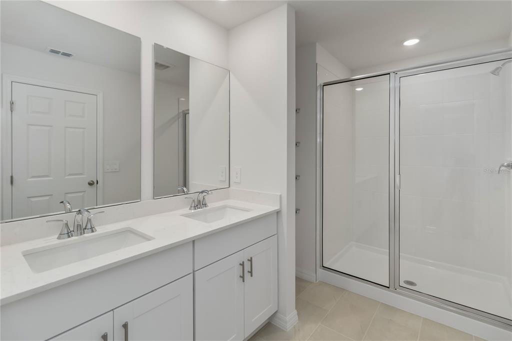 4569 Range Land Way St. Cloud, FL 34772 - Photo 18 of 41 a bathroom with double sink and a mirror