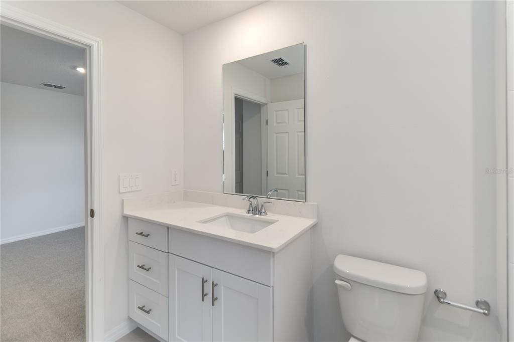 4569 Range Land Way St. Cloud, FL 34772 - Photo 21 of 41 a bathroom with a toilet sink and mirror