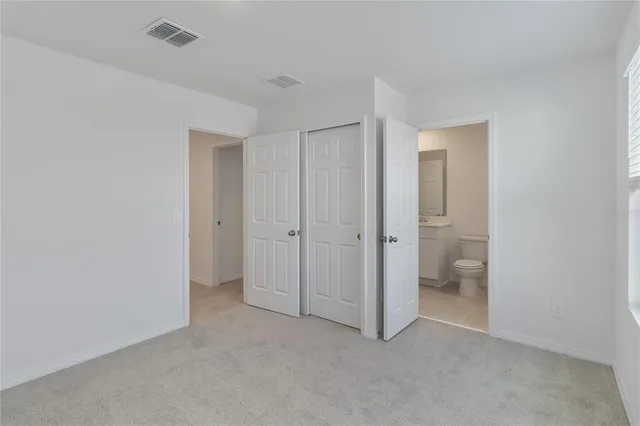 a view of an empty room and a bathroom