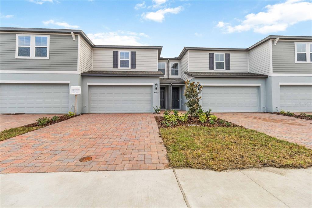 4569 Range Land Way St. Cloud, FL 34772 - Photo 31 of 41 a front view of a house with a yard