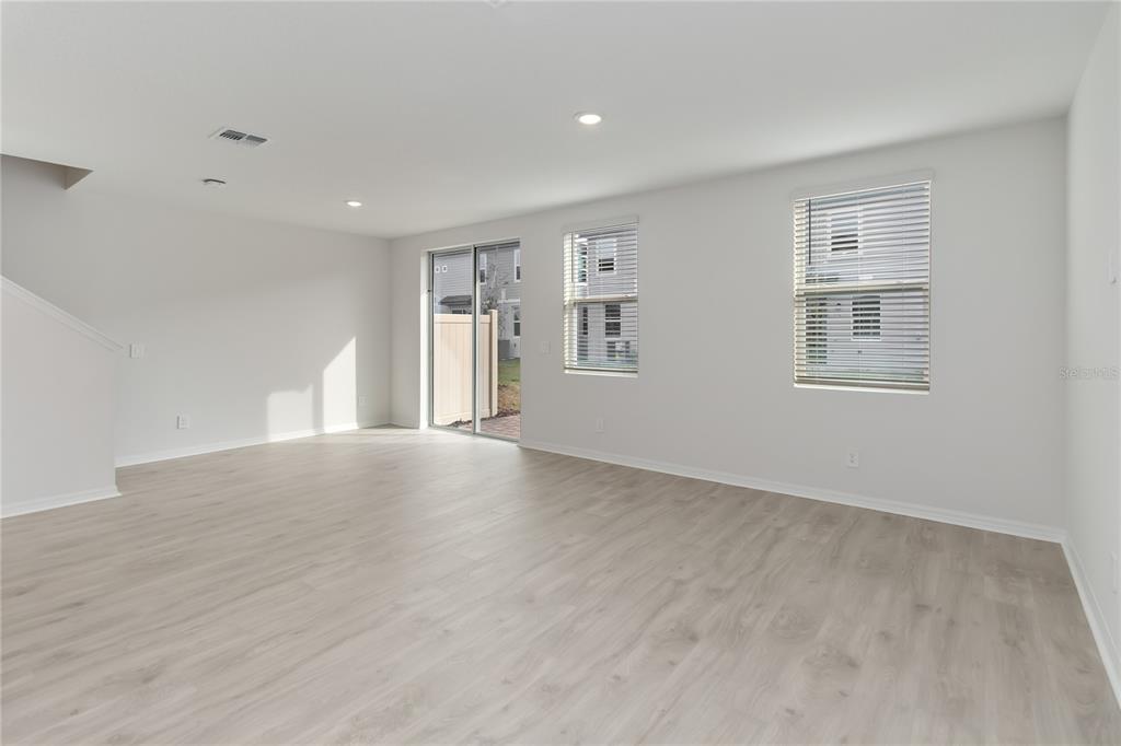 4569 Range Land Way St. Cloud, FL 34772 - Photo 7 of 41 a view of empty room with wooden floor and fan