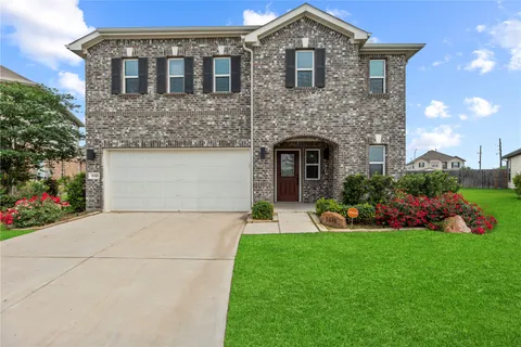 a front view of a house with a garden and plants