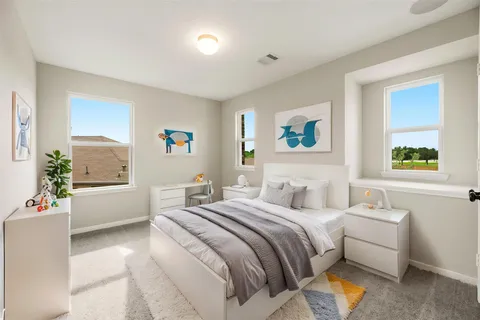 a bedroom with a bed and a couch