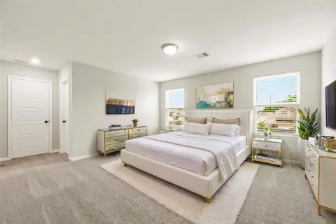 a spacious bedroom with a bed and a couch