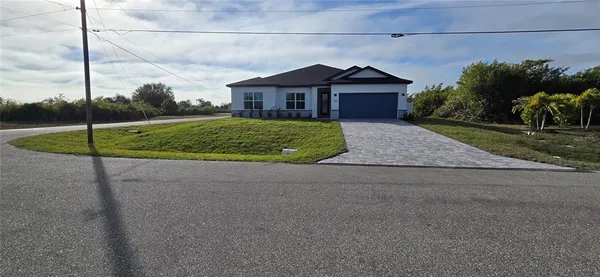 a house with green field in front of it
