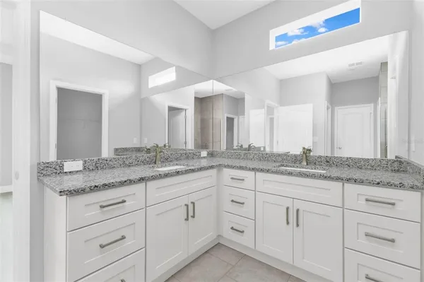 a bathroom with a shower and a glass door