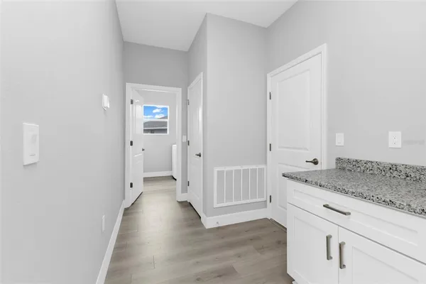 a view of hallway with wooden floor