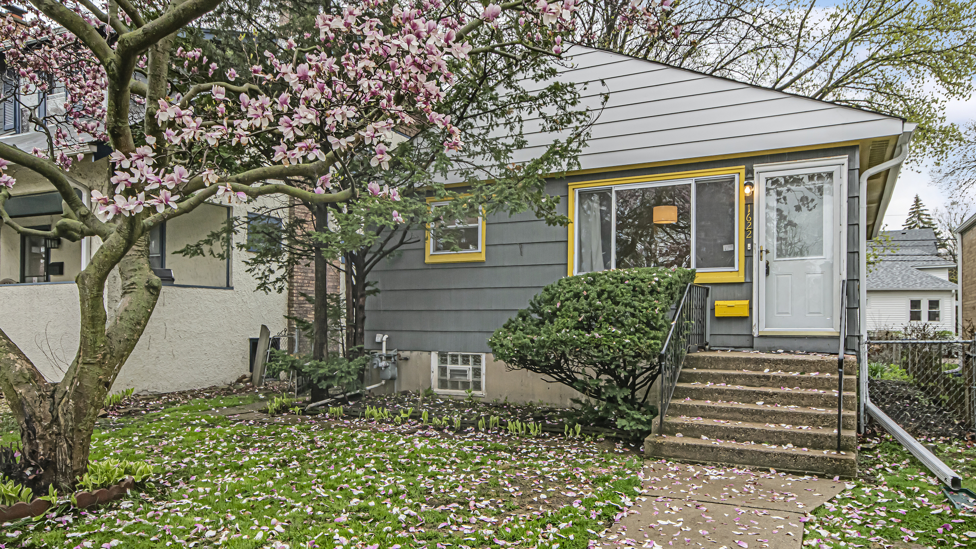 a front view of a house with a garden