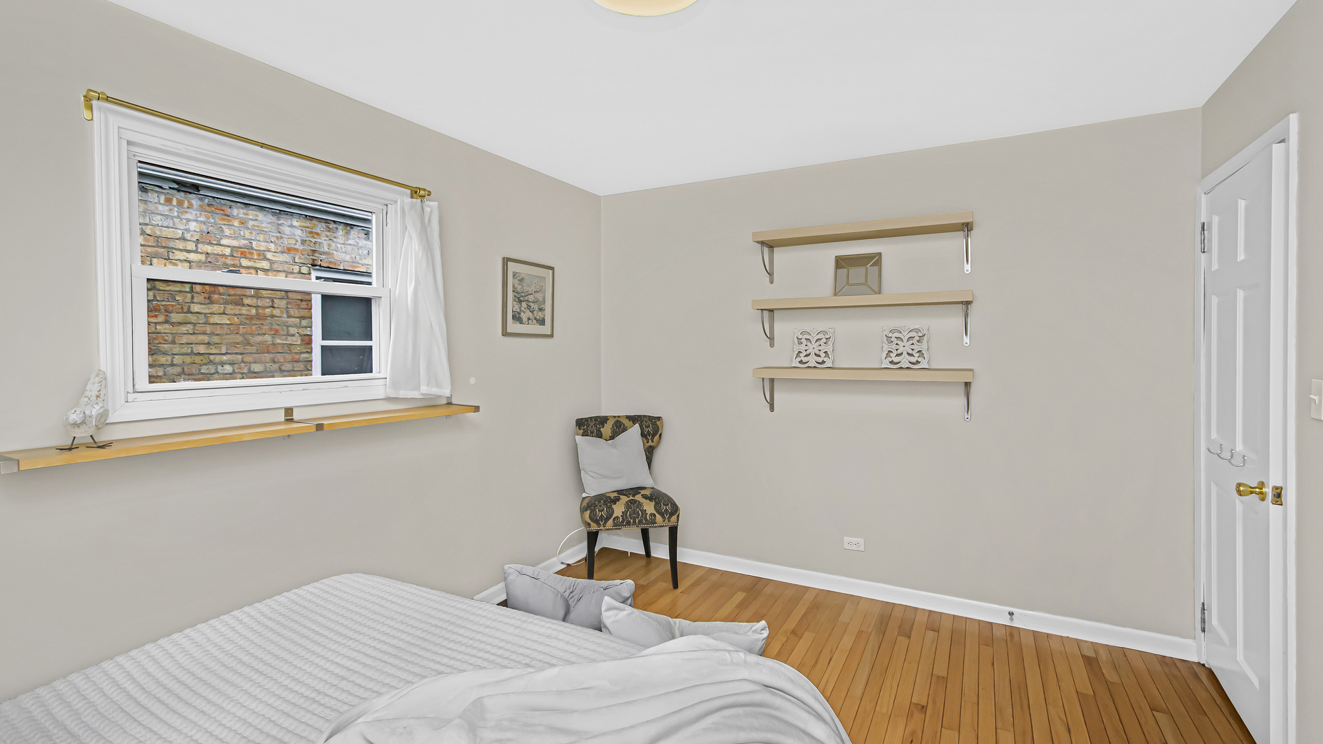 1622 Dempster Street Evanston, IL 60202 - Photo 11 of 21 a bedroom with a bed and a window