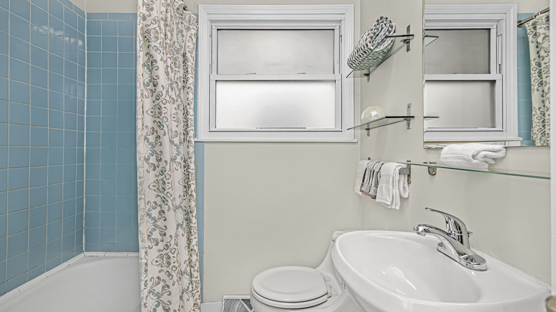 1622 Dempster Street Evanston, IL 60202 - Photo 14 of 21 a bathroom with a sink a toilet and shower