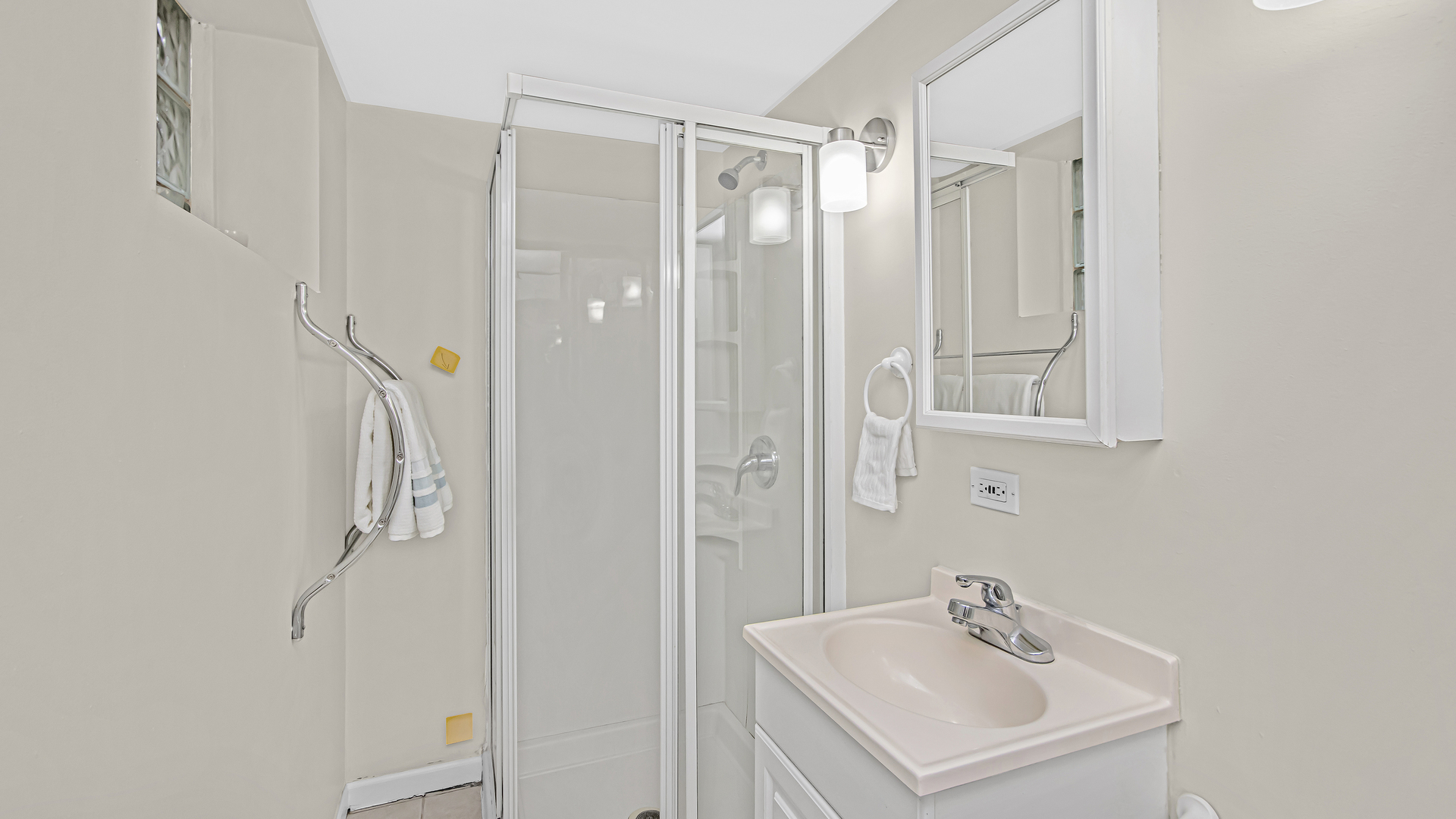 1622 Dempster Street Evanston, IL 60202 - Photo 17 of 21 a bathroom with a shower a sink and a mirror