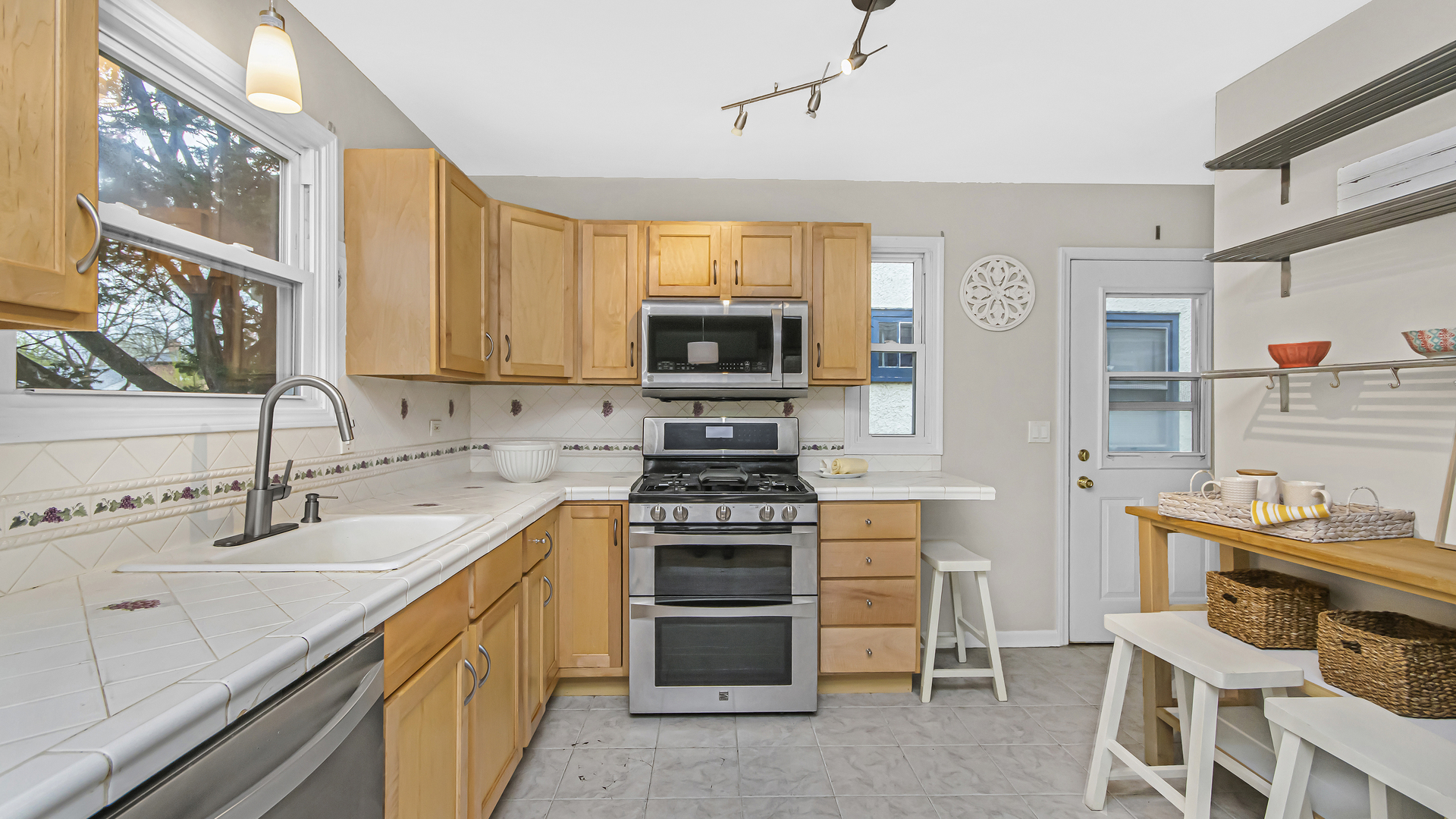 1622 Dempster Street Evanston, IL 60202 - Photo 7 of 21 a kitchen with stainless steel appliances a stove a sink and a microwave