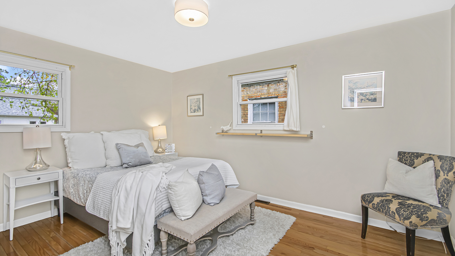 1622 Dempster Street Evanston, IL 60202 - Photo 9 of 21 a bedroom with a bed and a chair