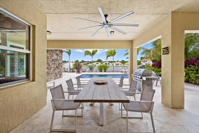 a dining room with a large window and chairs