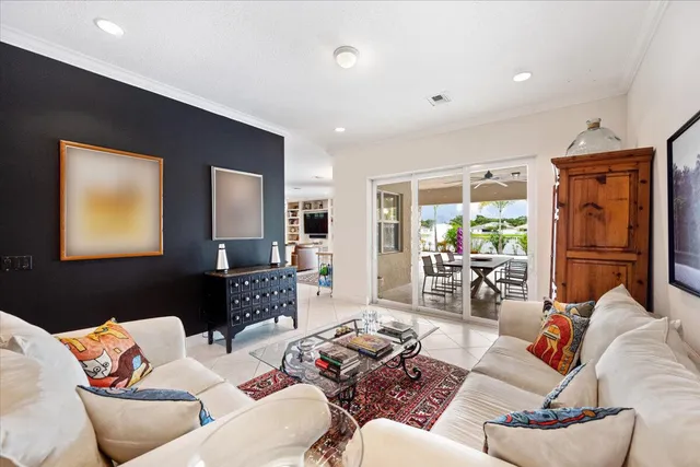 a living room with furniture a chandelier and a large mirror