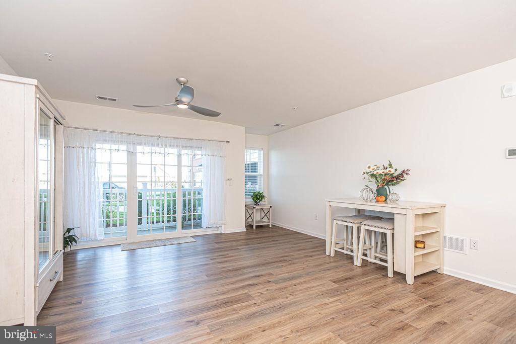 20141 Riesling Lane, Unit 106 Lewes, DE 19958 - Photo 14 of 31 a living room with furniture and a wooden floor