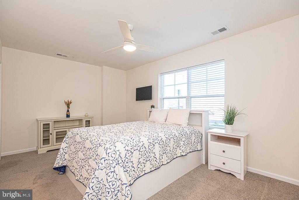 20141 Riesling Lane, Unit 106 Lewes, DE 19958 - Photo 17 of 31 a bedroom with a bed and a window
