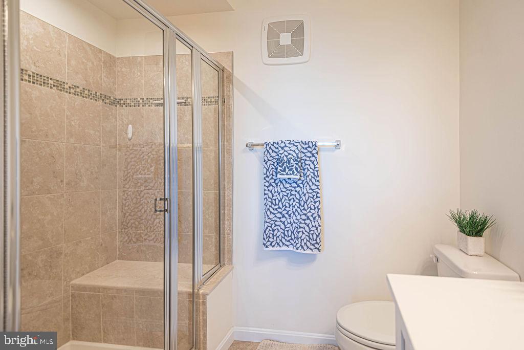 20141 Riesling Lane, Unit 106 Lewes, DE 19958 - Photo 19 of 31 a bathroom with a toilet and a shower