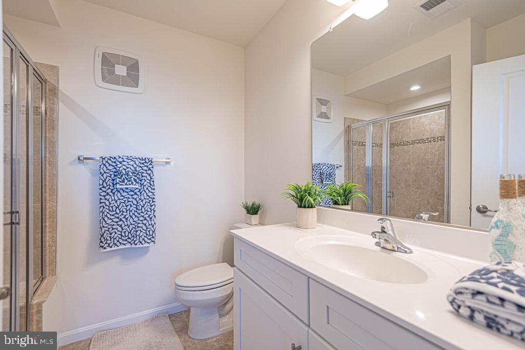 20141 Riesling Lane, Unit 106 Lewes, DE 19958 - Photo 20 of 31 a bathroom with a sink and a mirror