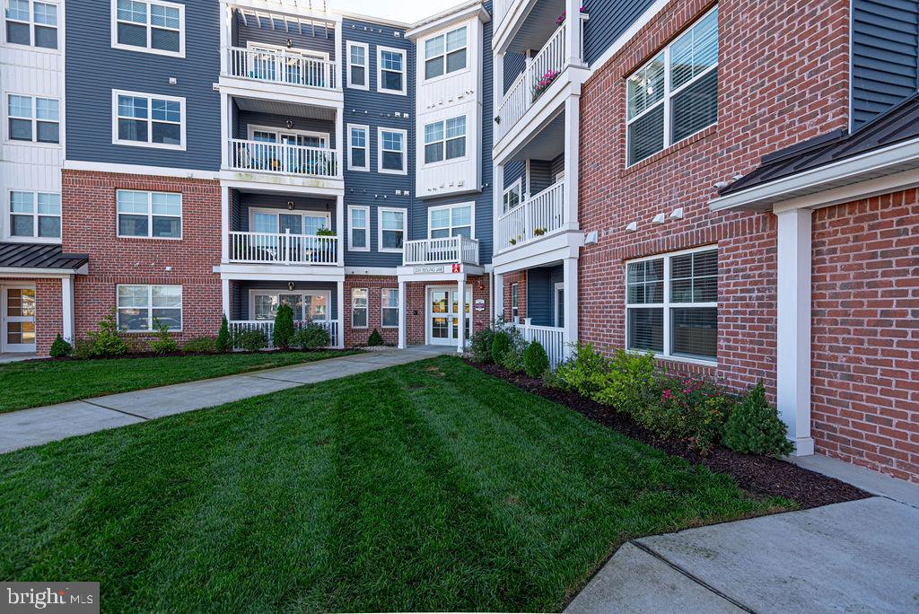 20141 Riesling Lane, Unit 106 Lewes, DE 19958 - Photo 2 of 31 a building view with a garden space