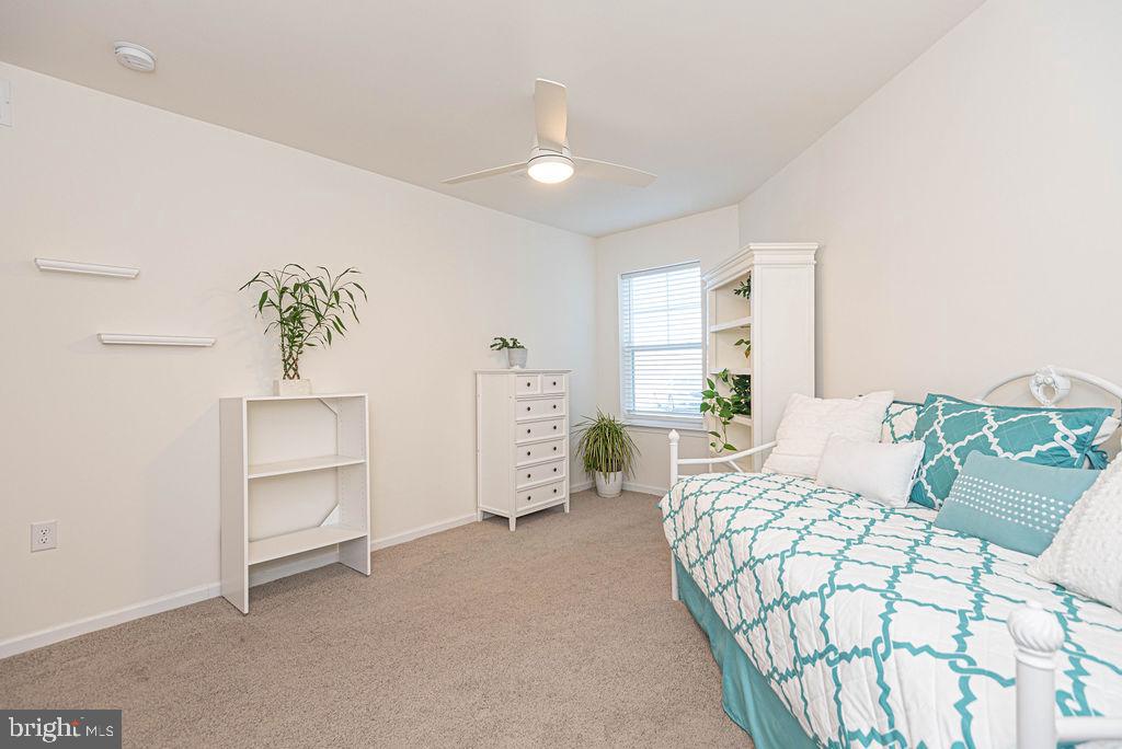 20141 Riesling Lane, Unit 106 Lewes, DE 19958 - Photo 23 of 31 a bedroom with a bed and a couch