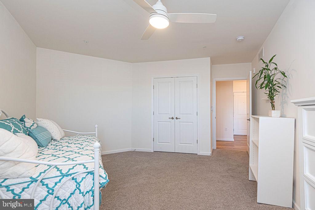 20141 Riesling Lane, Unit 106 Lewes, DE 19958 - Photo 24 of 31 a bedroom with a bed and a white cabinets