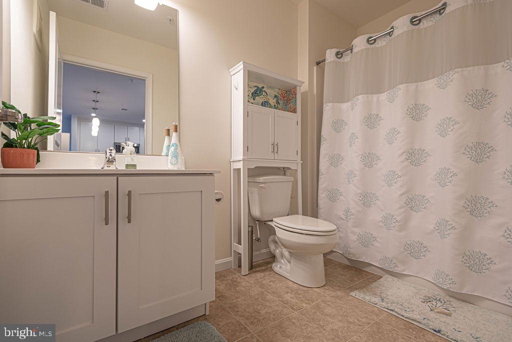20141 Riesling Lane, Unit 106 Lewes, DE 19958 - Photo 26 of 31 a bathroom with a sink a toilet and shower