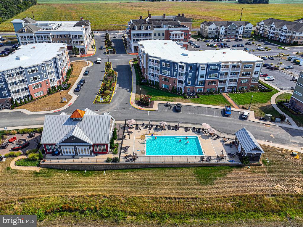 20141 Riesling Lane, Unit 106 Lewes, DE 19958 - Photo 30 of 31 a aerial view of a house with a swimming pool yard and outdoor seating