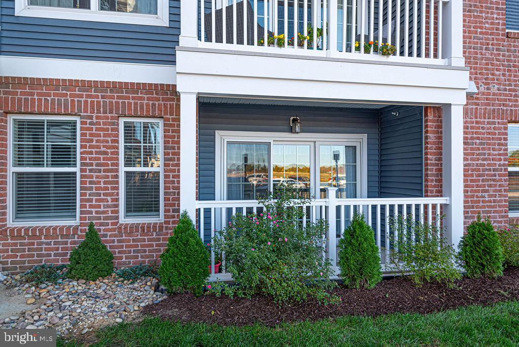 20141 Riesling Lane, Unit 106 Lewes, DE 19958 - Photo 3 of 31 a view of a house with large windows and plants