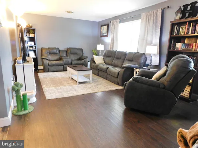 a living room with furniture and a book shelf