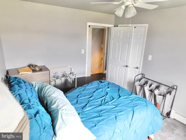 a bedroom with two beds and a chandelier