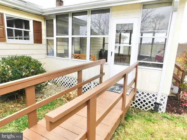 a view of a balcony with wooden floor and fence