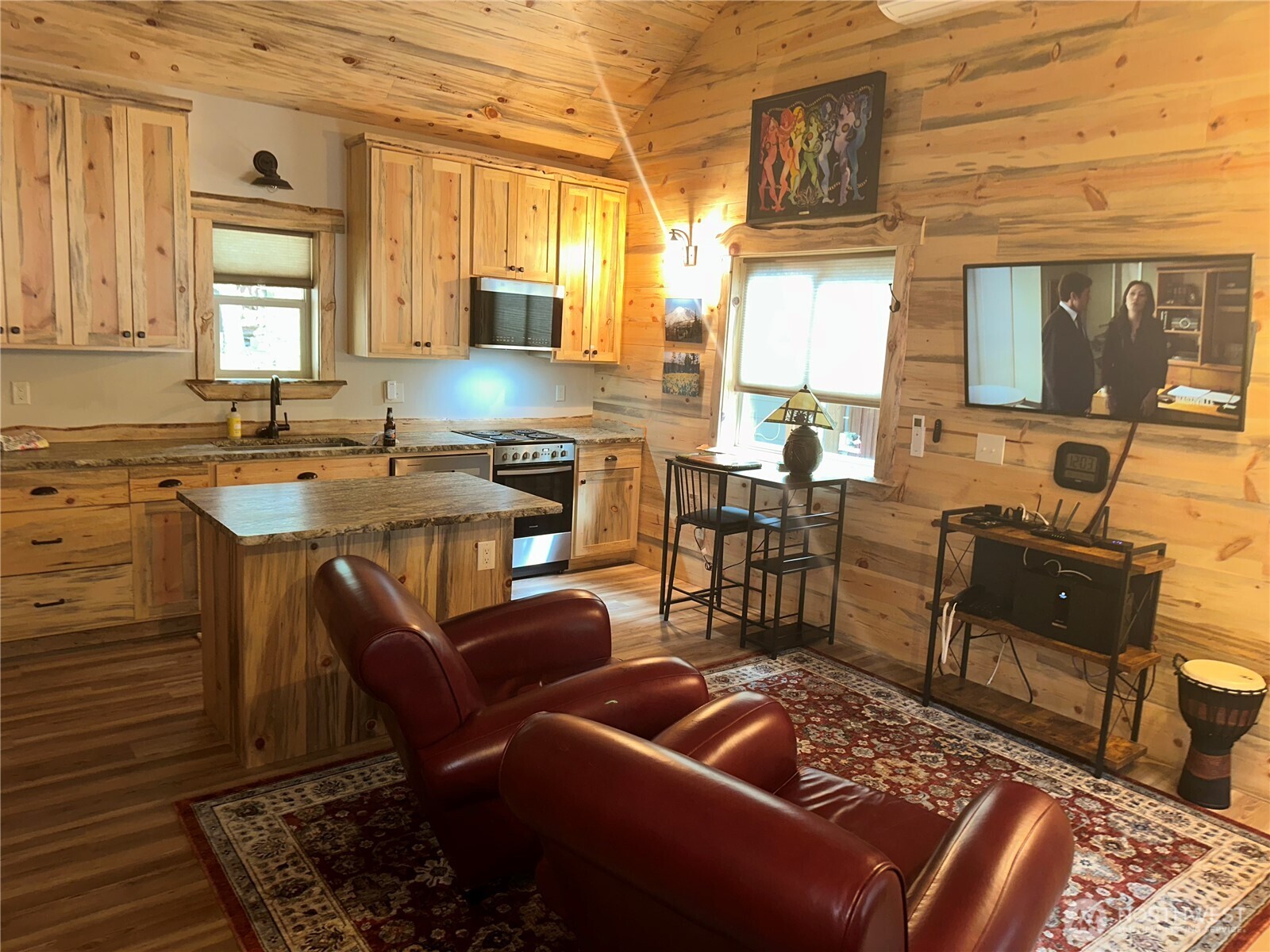 22415 Stirrup Road Leavenworth, WA 98826 - Photo 17 of 19 a kitchen with stainless steel appliances granite countertop a stove a sink a dining table and chairs with wooden floor