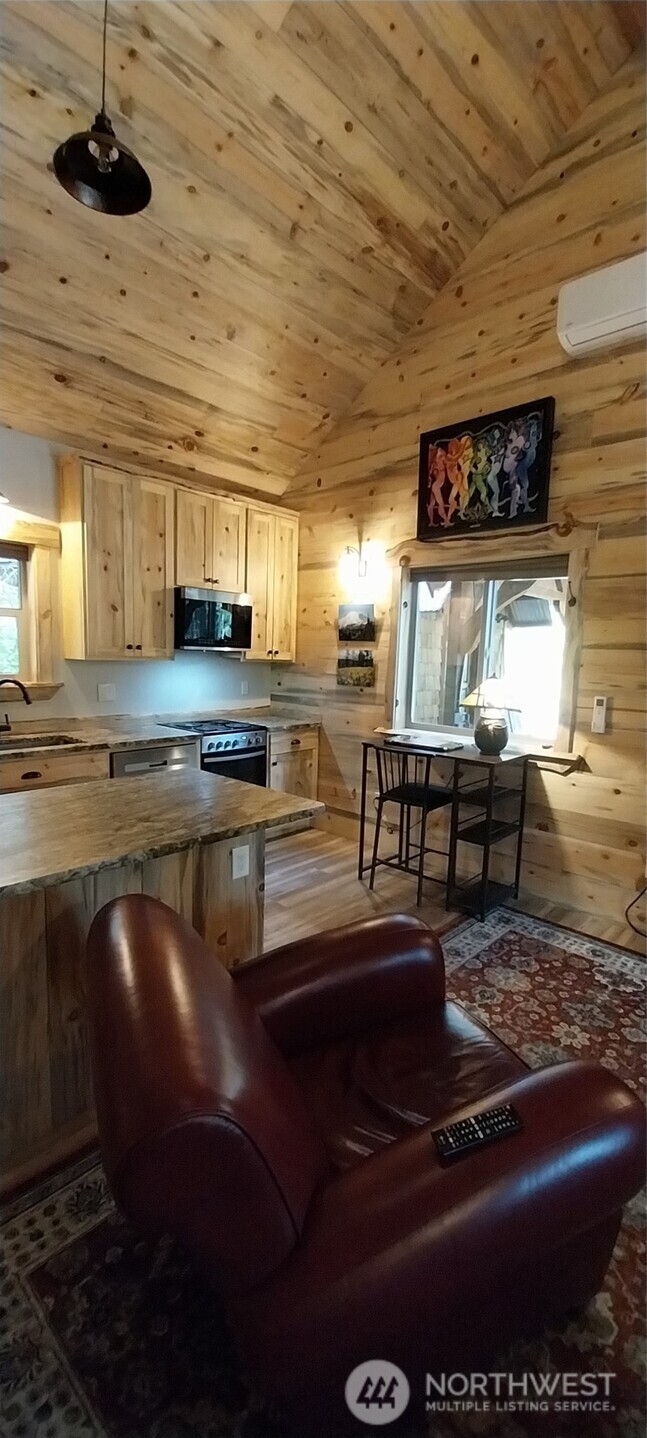 22415 Stirrup Road Leavenworth, WA 98826 - Photo 6 of 19 a kitchen with stainless steel appliances granite countertop a stove a sink and a microwave