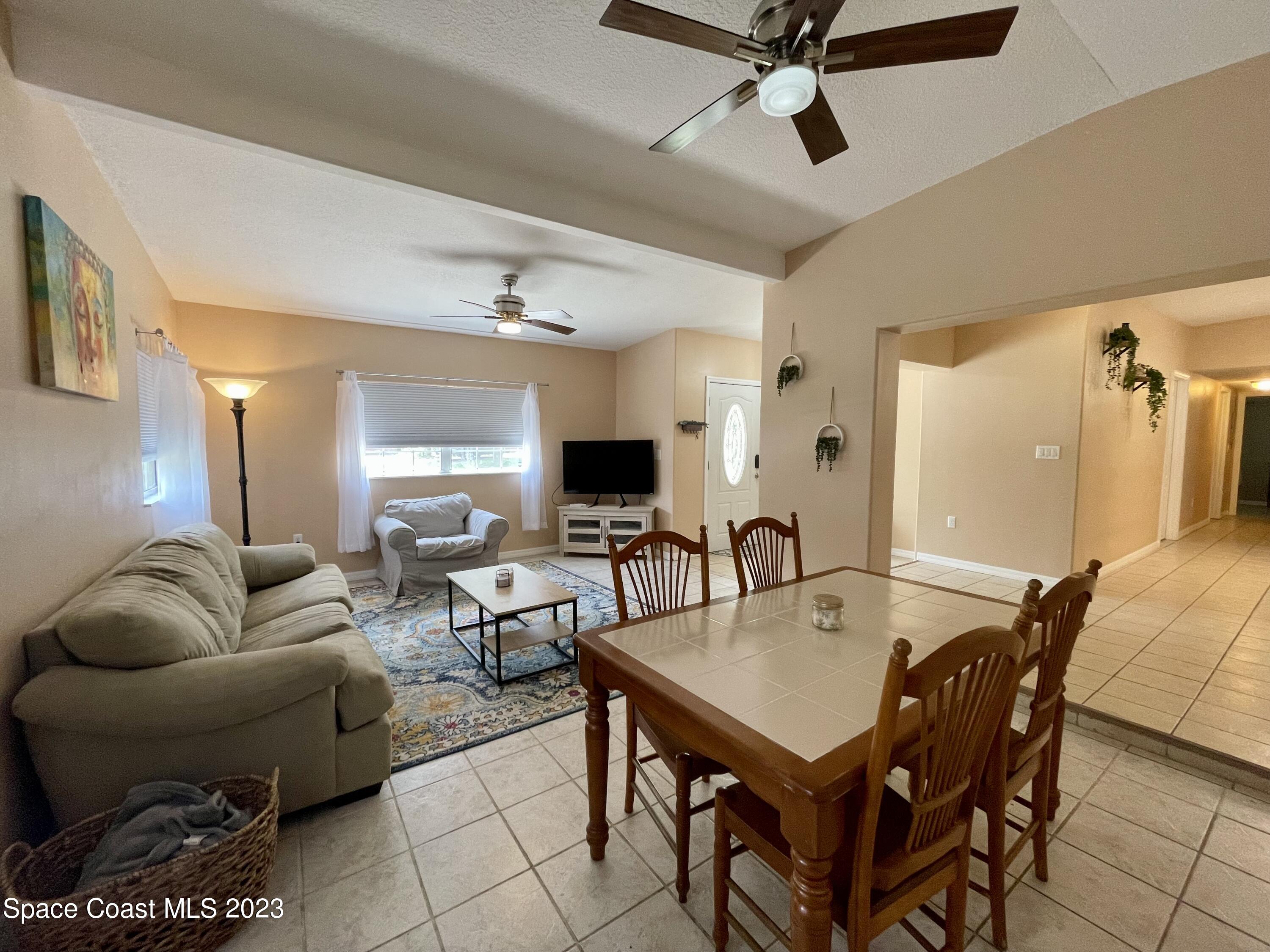 255 Lee Road Melbourne, FL 32904 - Photo 5 of 20 a living room with furniture a rug and a flat screen tv