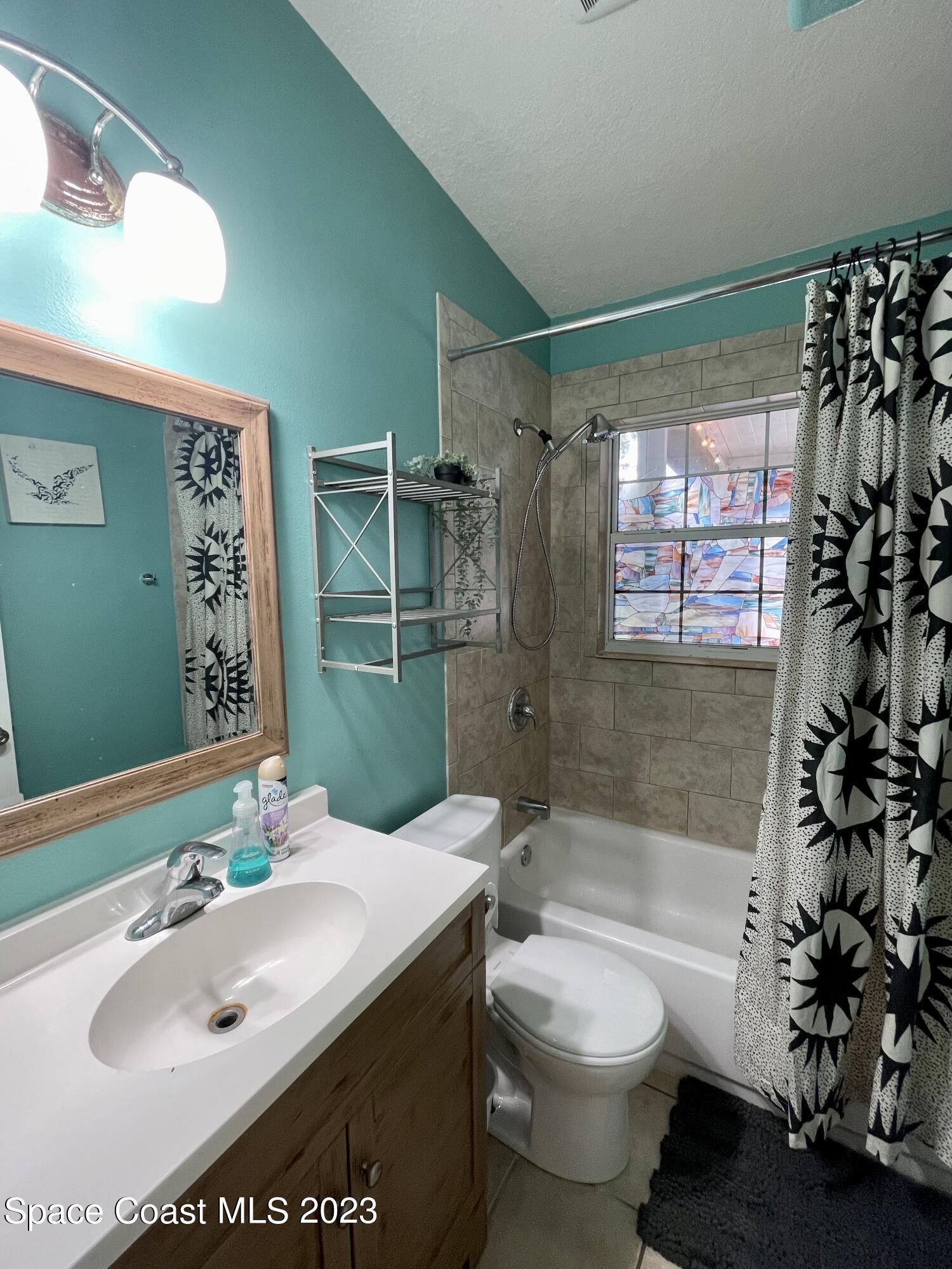 255 Lee Road Melbourne, FL 32904 - Photo 7 of 20 a bathroom with a sink toilet and shower