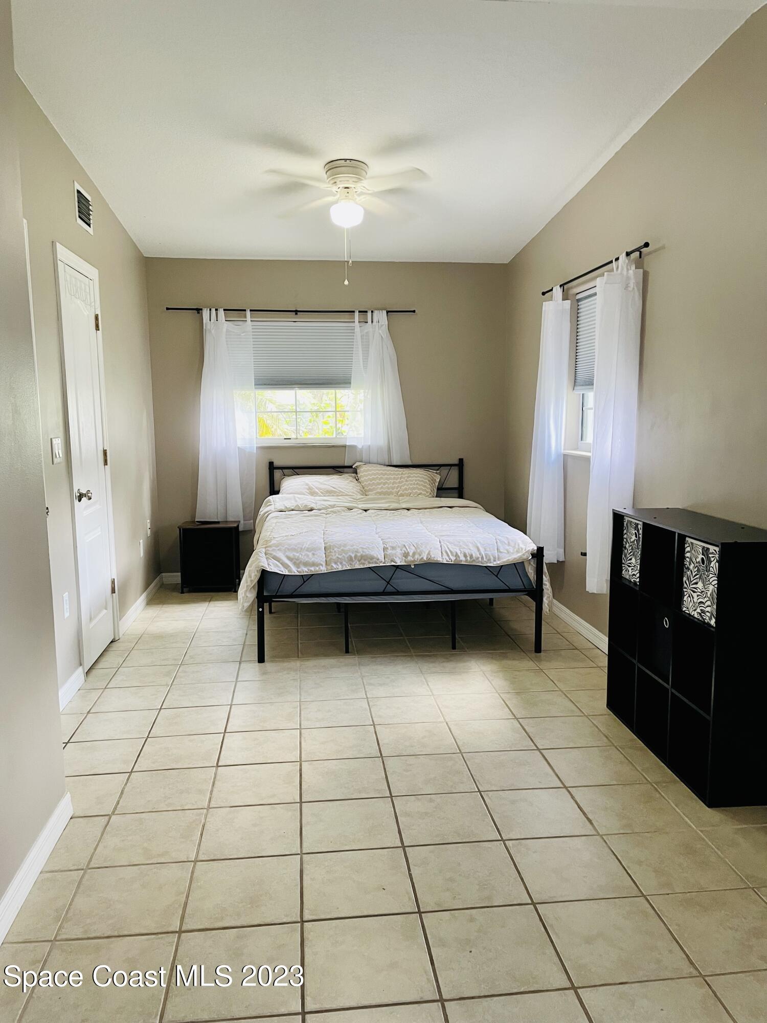 255 Lee Road Melbourne, FL 32904 - Photo 9 of 20 a bedroom with a bed and a window