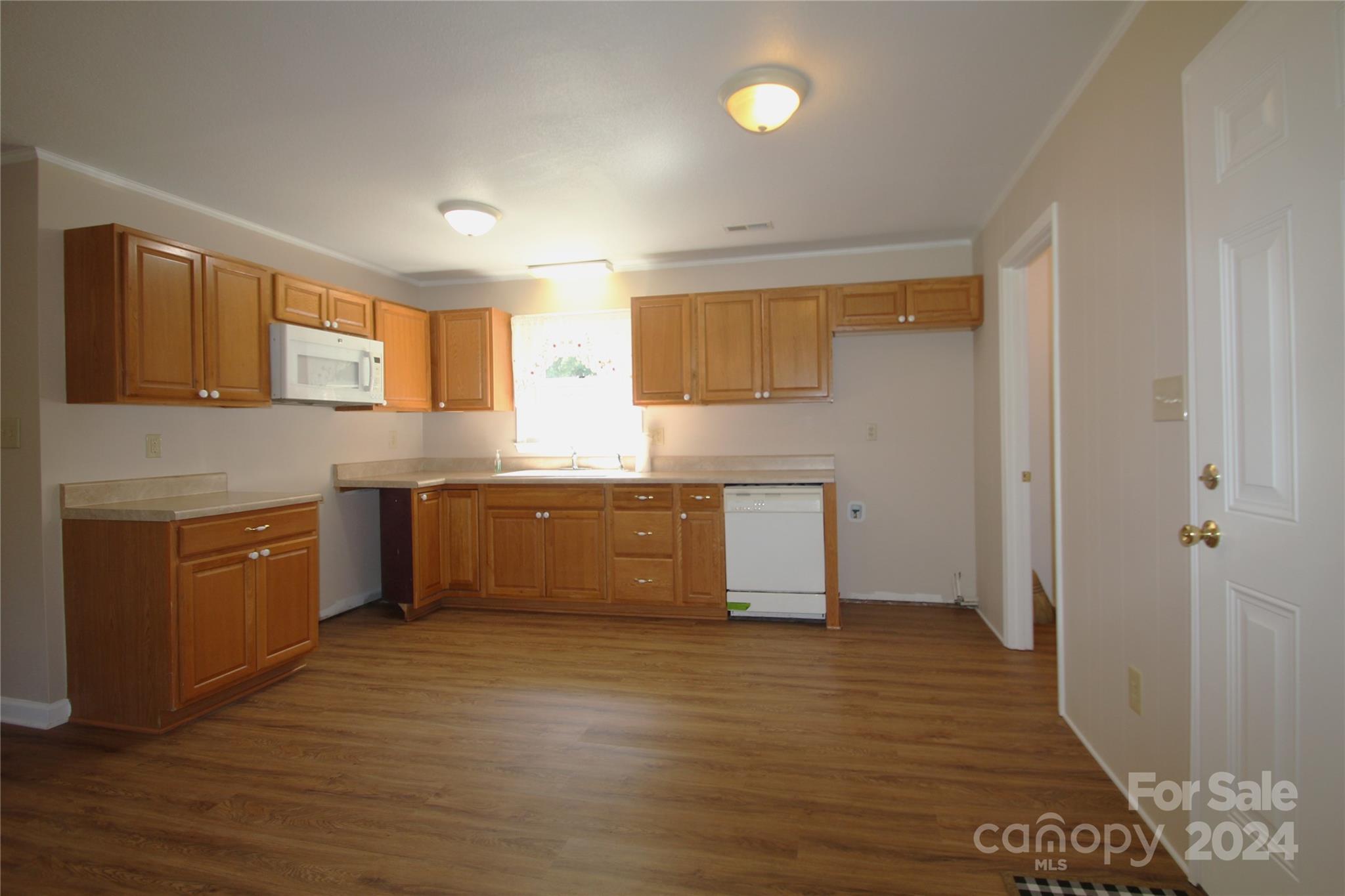 1049 Bethlehem Church Road Grover, NC 28073 - Photo 5 of 14 a view of a kitchen with a sink wooden cabinets and a window