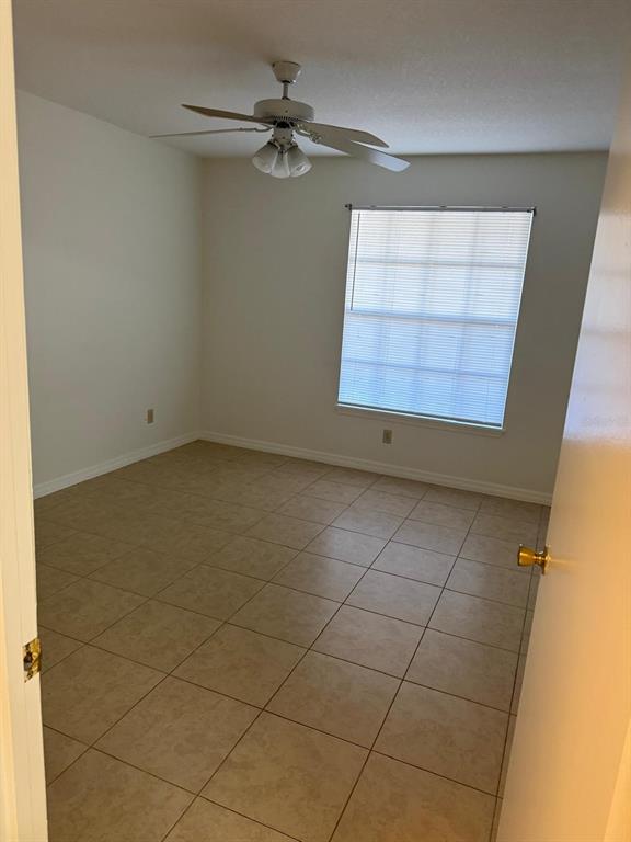 1057 South Hiawassee Road, Unit 1915 Orlando, FL 32835 - Photo 2 of 6 an empty room with windows