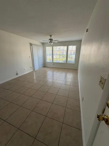 a view of an empty room and a window