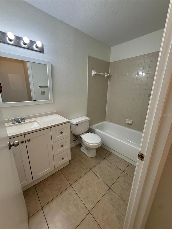 1057 South Hiawassee Road, Unit 1915 Orlando, FL 32835 - Photo 5 of 6 a bathroom with a double vanity sink toilet and mirror
